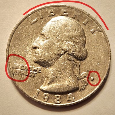 1984 quarter grease-filled die error showing missing or partial letters in LIBERTY or IN GOD WE TRUST motto